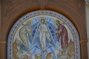 Intricate religious mosaic art depicting three figures in a church setting.